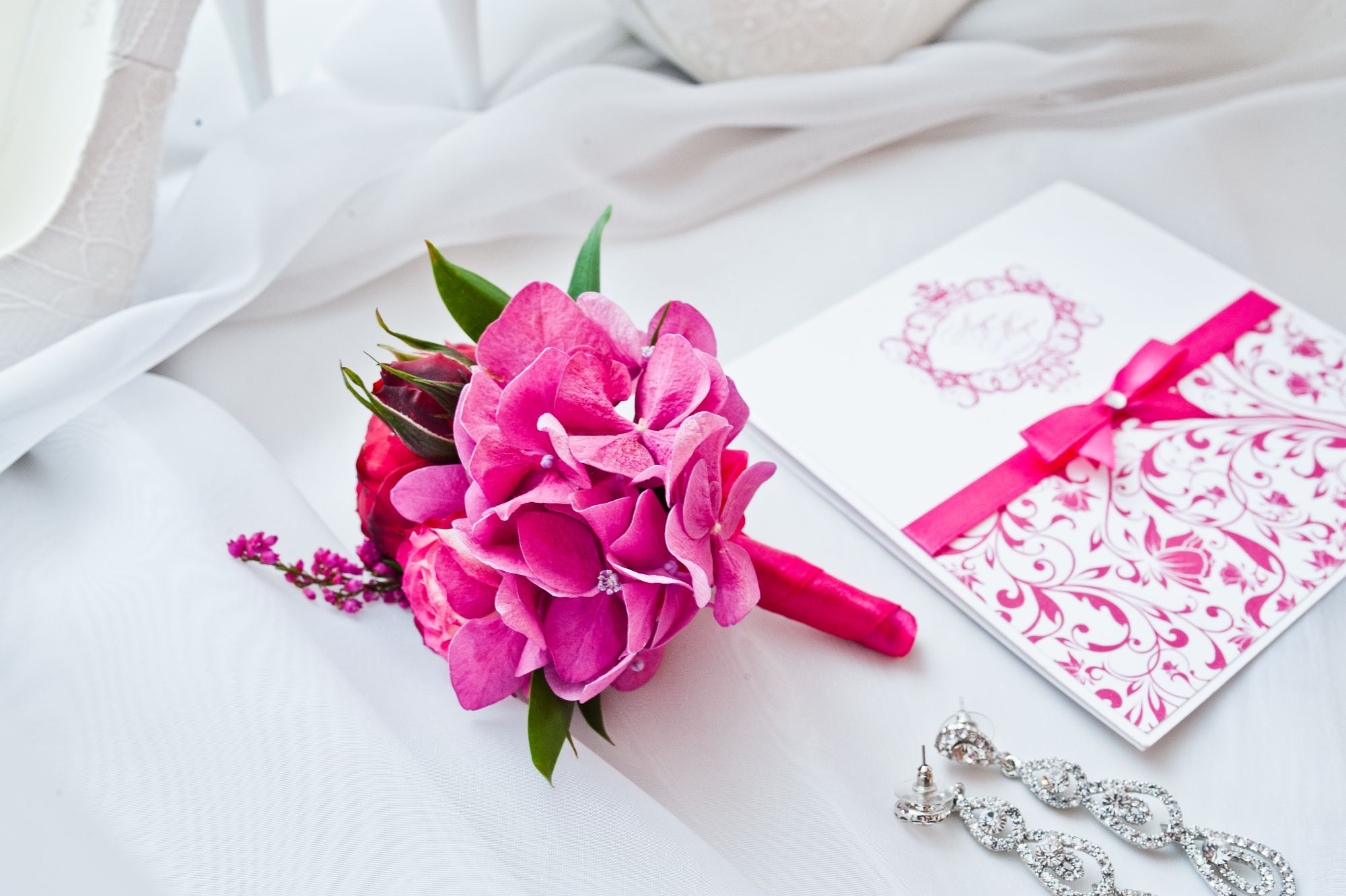 Laptop screen showing a digital invitation maker with elegant templates and RSVP tracking