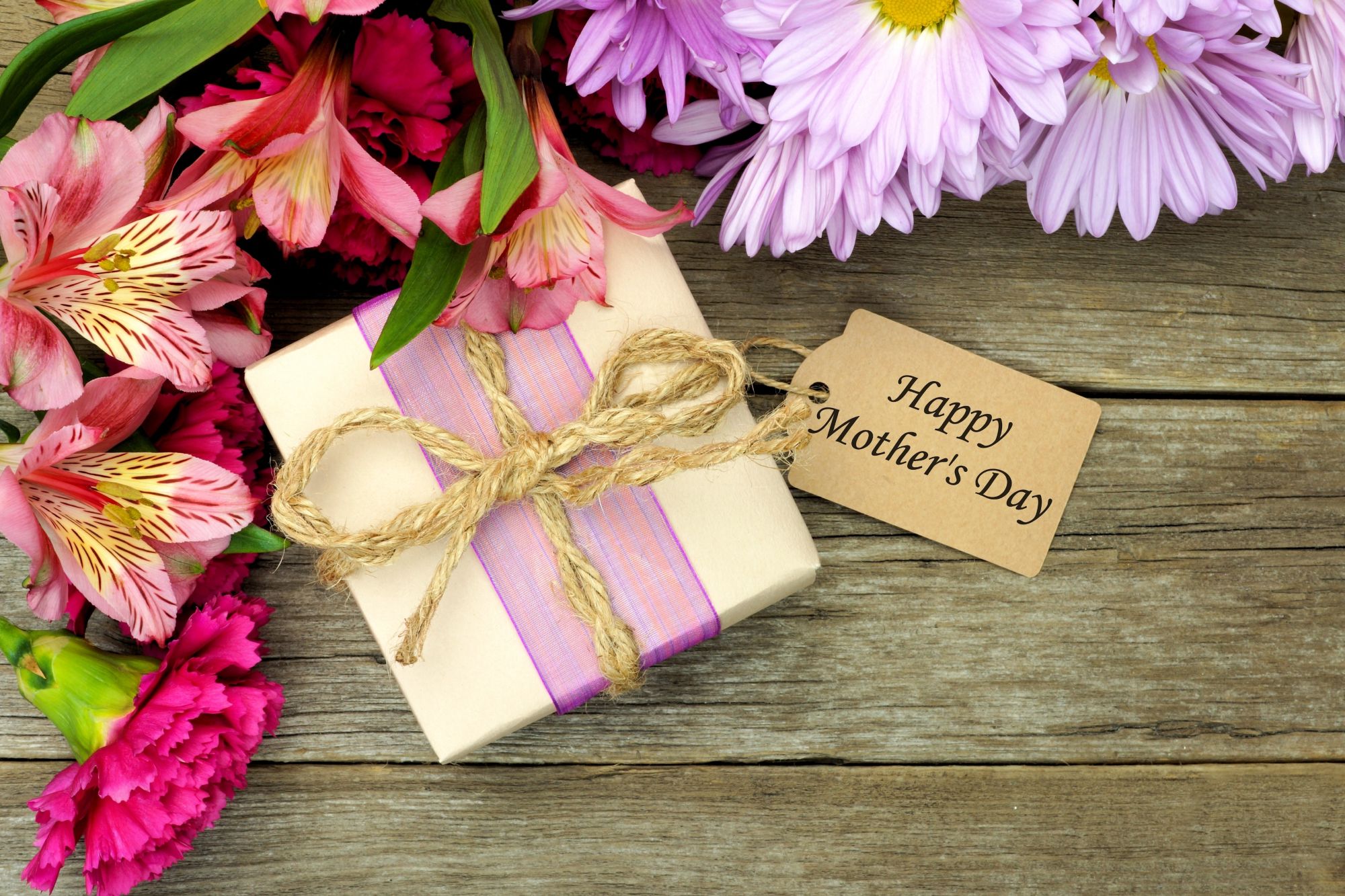 Beautifully wrapped personalised Mother's Day gift with pink ribbon and flowers