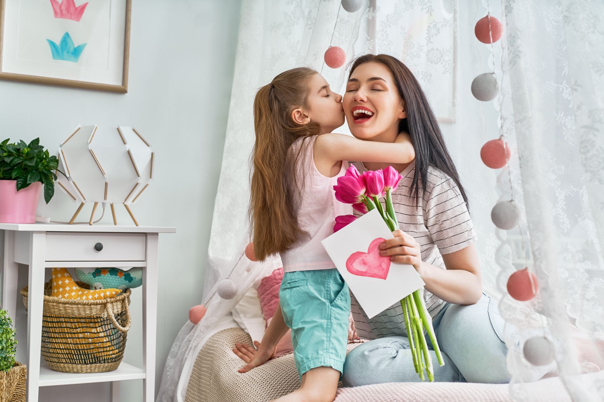 Mum opening a personalised Mother's Day gift with delighted family looking on