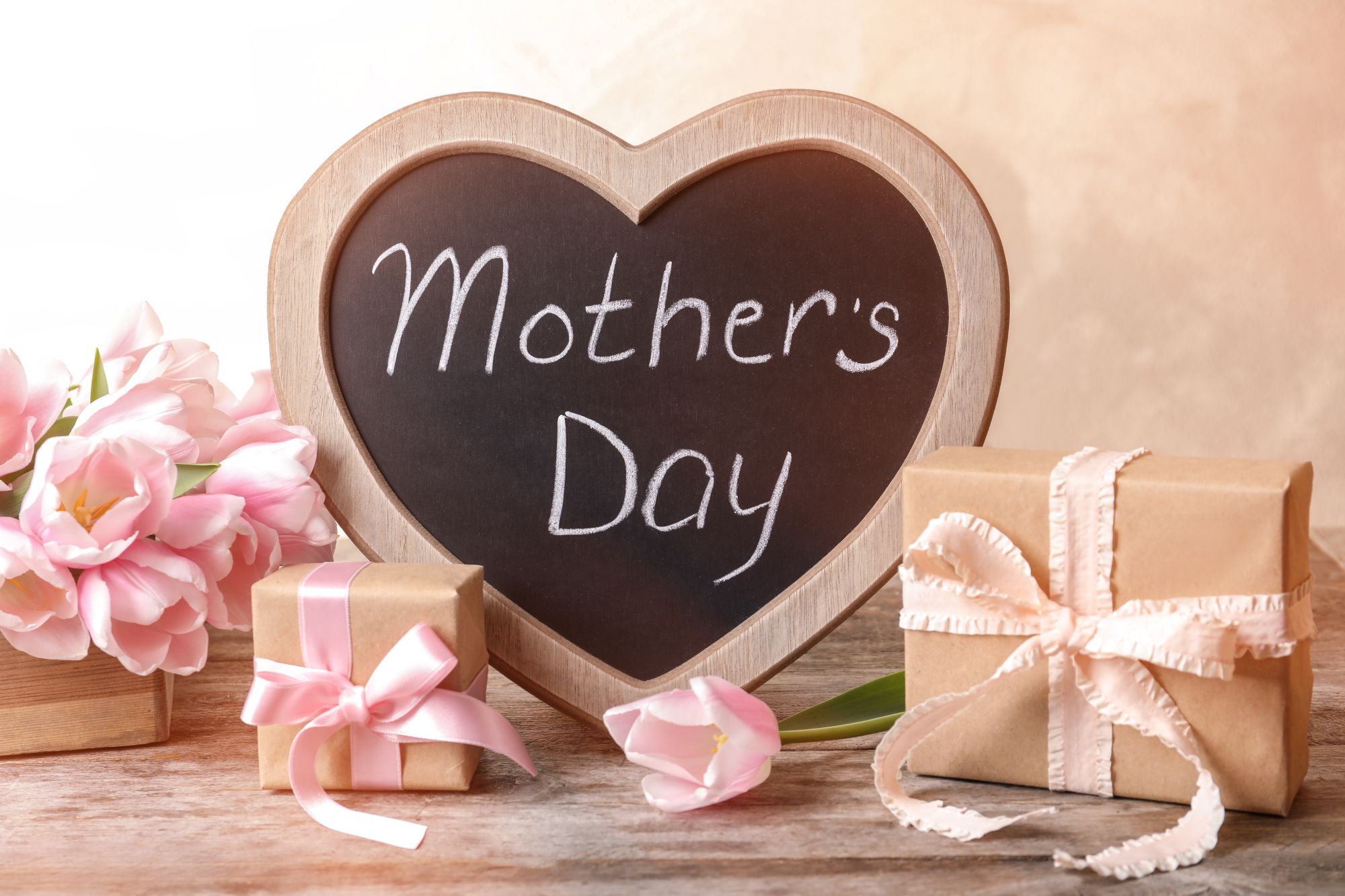 Mother smiling as she listens to a personalised voice greeting card from her child